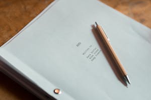Close-up of a film script titled 'Soul' next to a pen on a wooden desk.